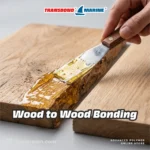 Transbond Marine Multisubstrate Epoxy Adhesive kit, 1kg Resin Part A and 800g Hardener Part B containers. Transbond Marine Multisubstrate Epoxy Adhesive suitable for bonding wood, metal, stone, concrete, and ceramic. Transbond Marine Epoxy Adhesive specs: 60 min setting time, 100:80 mixing ratio, gel viscosity, high bond strength. Transbond Marine Epoxy Adhesive: 30 min pot-life, 100:80 mix ratio, 300 min cure. Pack sizes: 450g, 1.8kg, 9kg. Transbond Marine Epoxy Adhesive demonstrating high-strength metal to stone bonding with thick amber gel. Transbond Marine Epoxy Adhesive used for metal to wood bonding, clamped tightly with amber gel visible. Applying Transbond Marine Epoxy Adhesive with a putty knife for strong wood to wood bonding. Transbond Marine Epoxy Adhesive bonding a ceramic tile to a wood block, showing thick amber gel. Transbond Marine Epoxy Adhesive applied with a putty knife for concrete to stone bonding.